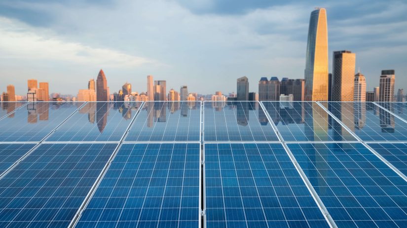 City landscape reflected in solar energy panels